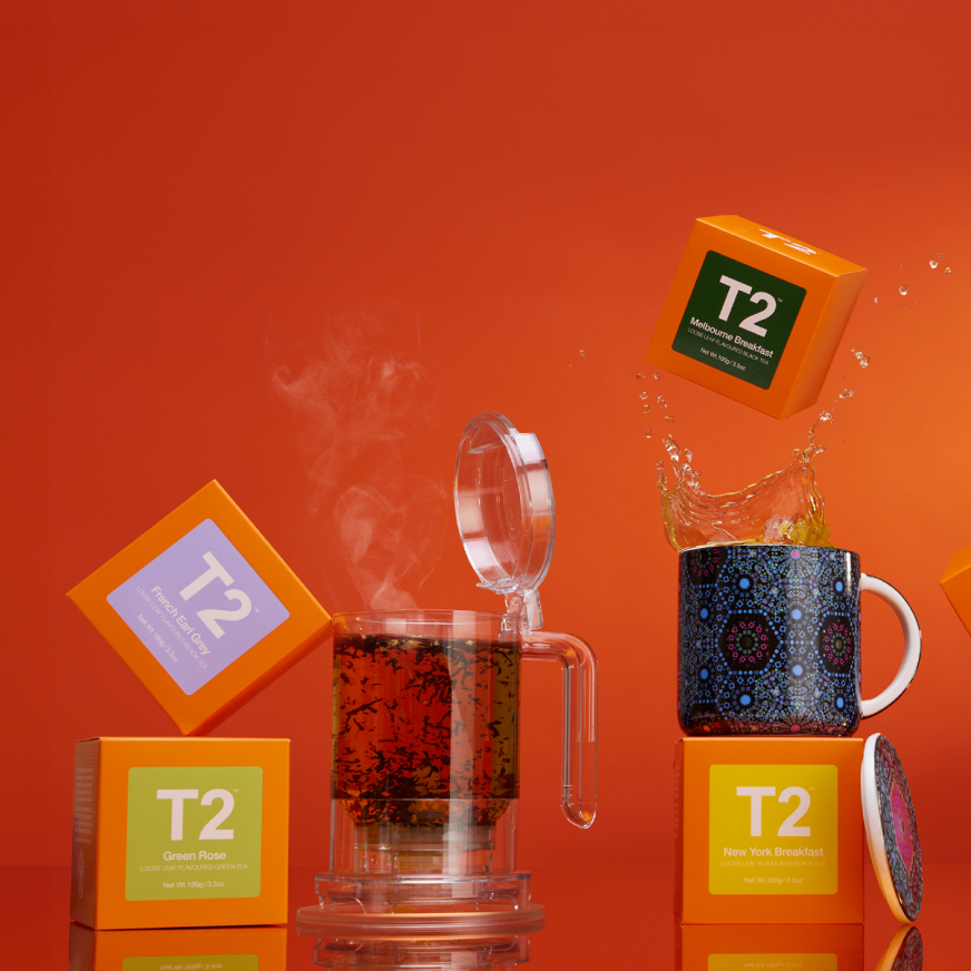 T2 teas in orange boxes with the Teamaker and mugs